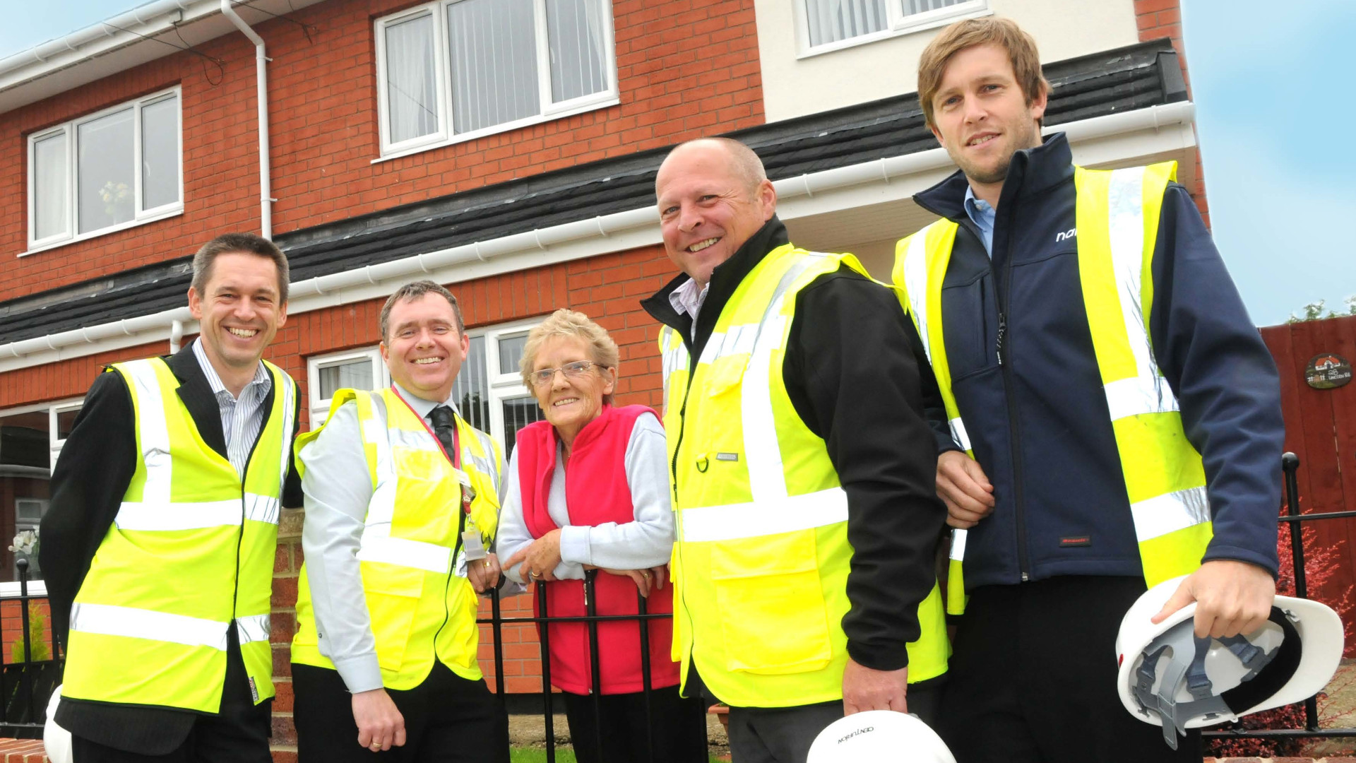 One of the improved homes, with representatives from South Tyneside Homes and the National Renewable Energy Centre