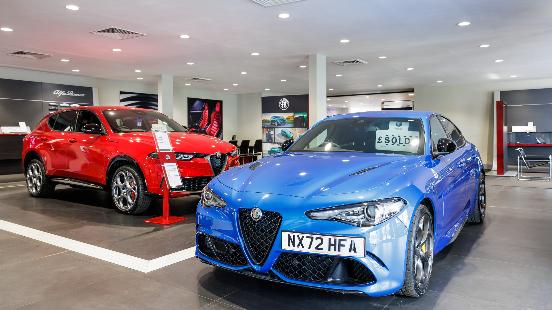 blue car and a red car inside a company