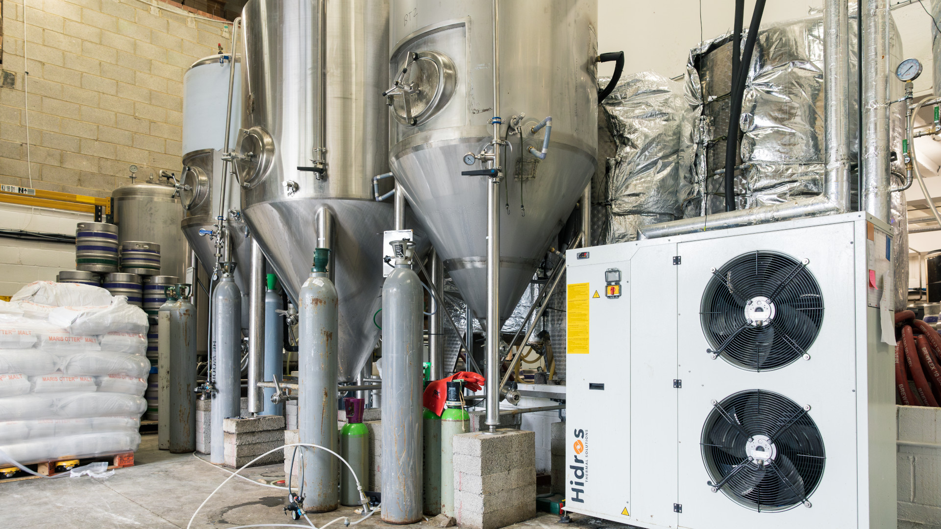 three fermenters in a brewing company