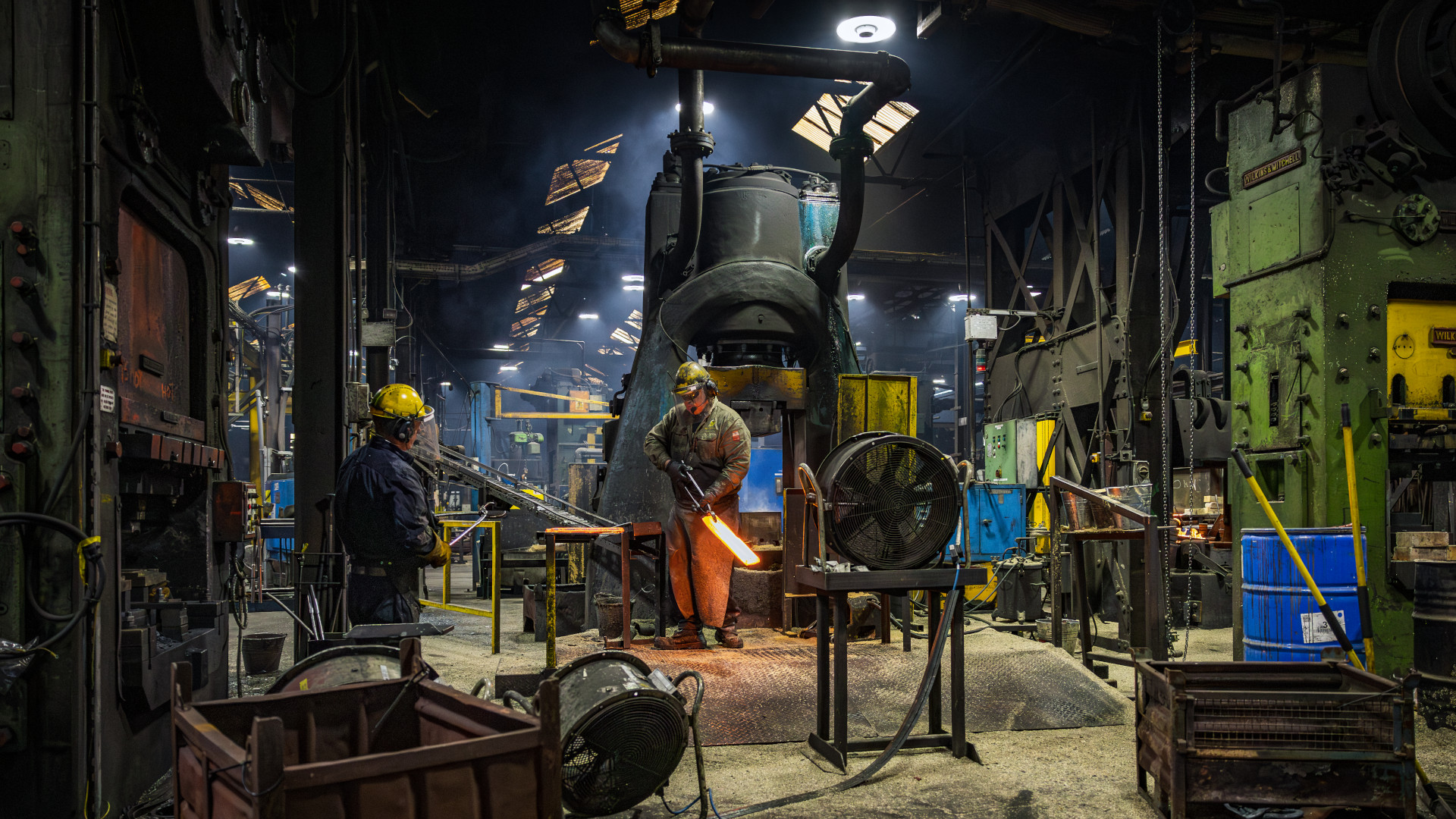 two men working on a factory