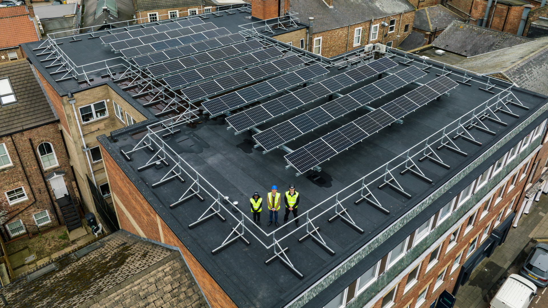 three people in a solar pannel roof